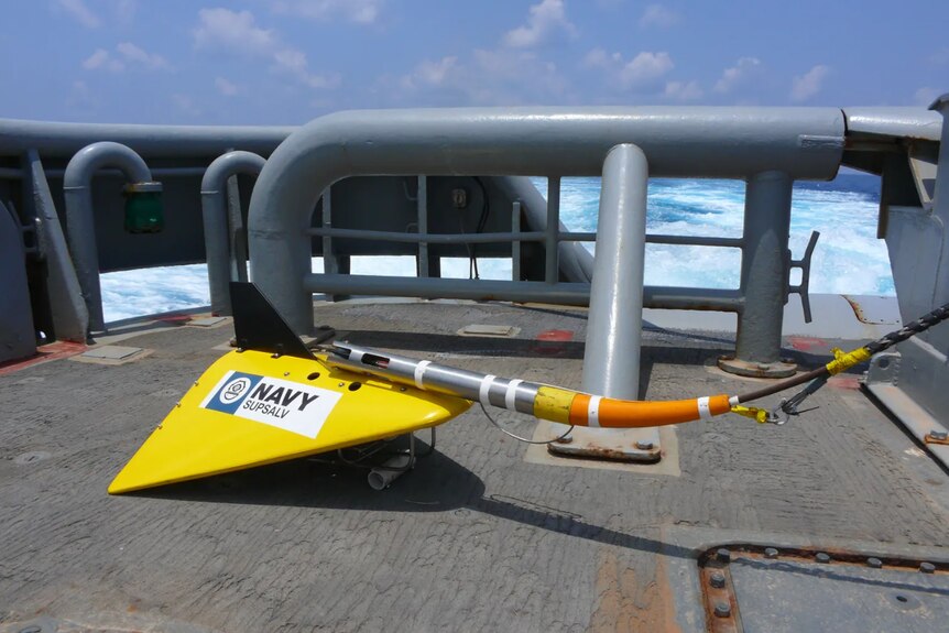 A yellow stingray looking device on a ship. 