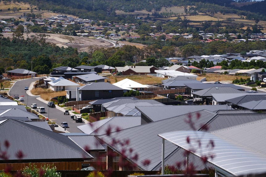 Aerial view showing lots of houses with grey roofs. 