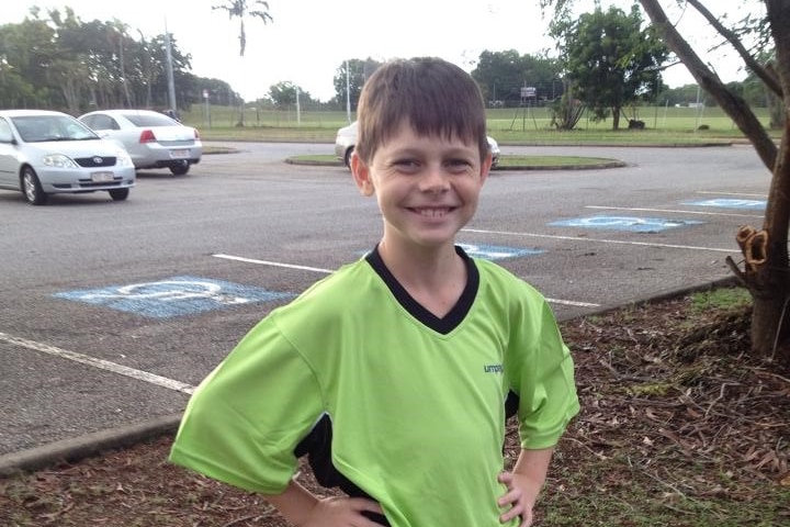 Jonty Beard wering a green umpiring shirt in a carpark.