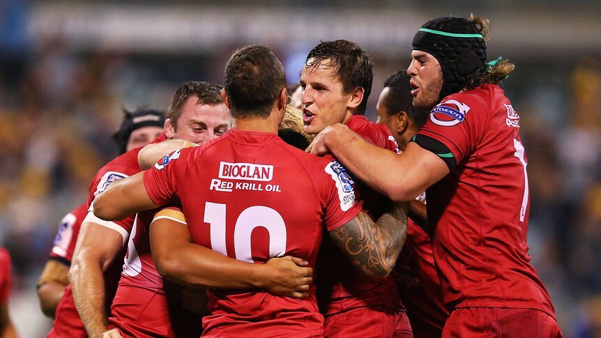 Confident mood ... The Reds celebrate during their win over the Brumbies