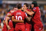 Gutsy effort ... The Reds celebrate their winning try