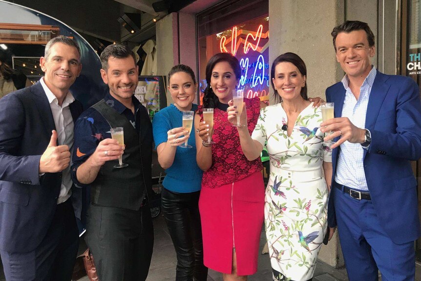 News Breakfast team each raise a glass of champagne on the 10th anniversary.