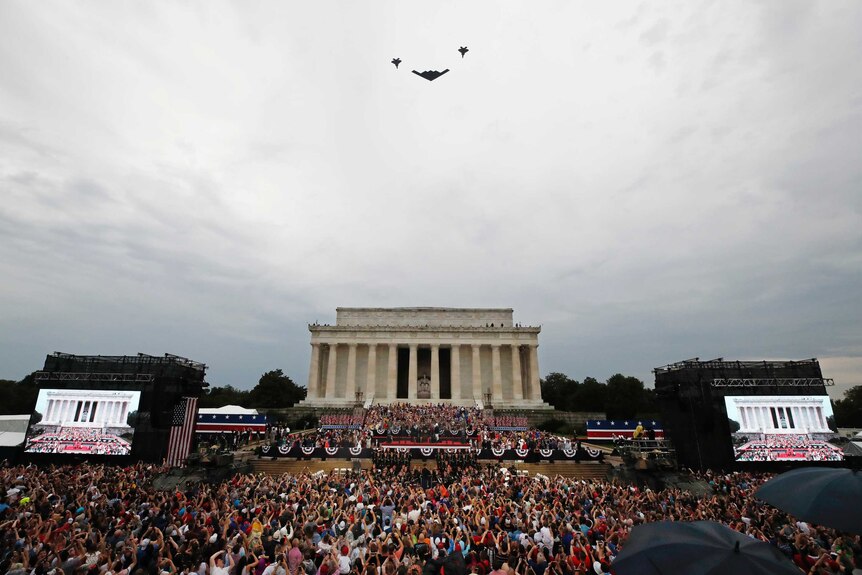 Military aircraft flyover the Lincoln Memorial on the Fourth of July while Donald Trump is on stage