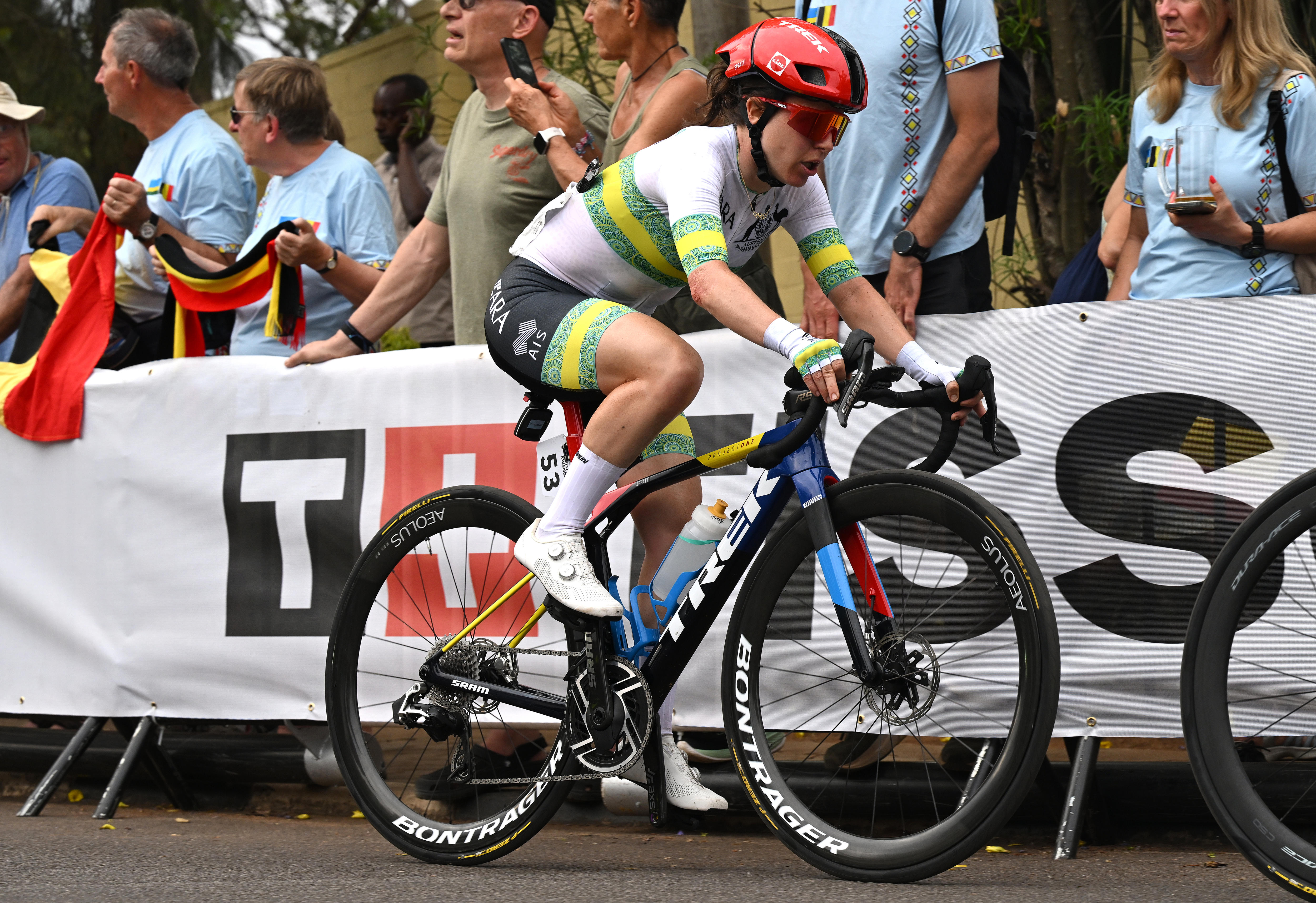 Amanda Spratt  rides past a group of fans