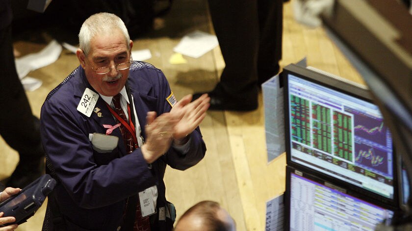 Trader claps on the floor of the New York Stock Exchange