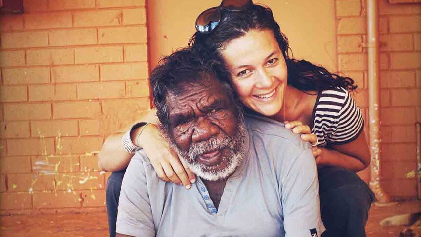 Ms Alfonso hugs an Indigenous artist by the name of Paddy Stewart.