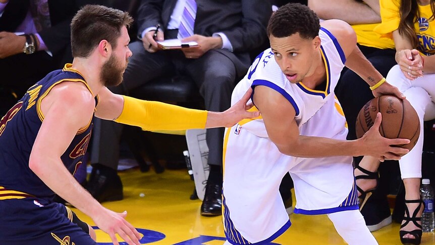 Golden State's Stephen Curry under pressure from Cleveland's Matthew Dellavedova in NBA Finals.