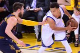 Golden State's Stephen Curry under pressure from Cleveland's Matthew Dellavedova in NBA Finals.