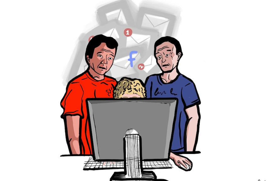 Two adult men stand around a boy on a computer looking concerned