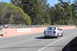 A car drives on Paul Pisasale Bridge, Sinnathamby Boulevard, Springfield Central, west of Brisbane.