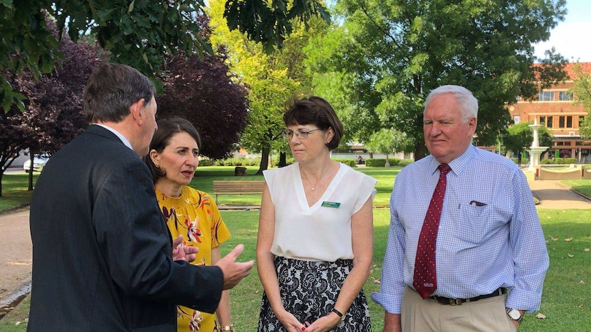 Four NSW politicians, including Premier Gladys Berejiklian, speaking in a park in Orange.