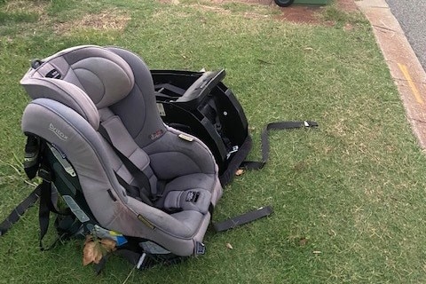 Two child car seats discarded on a verge.