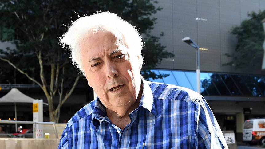 Businessman and former federal MP Clive Palmer arrives holding a sick bag to the Federal Court in Brisbane on May 16, 2017