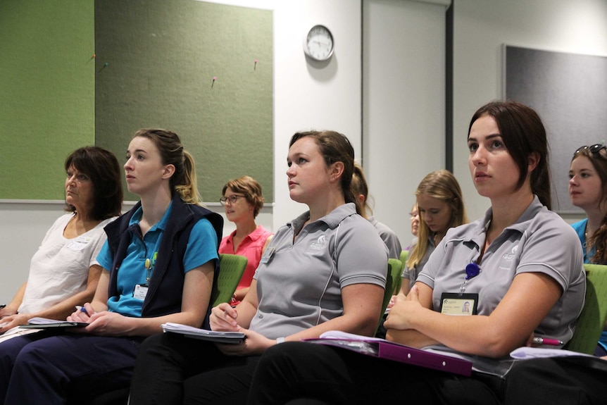 Healthcare workers and students learn about post-polio.