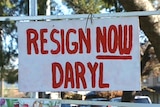 A sign reading resign now Daryl