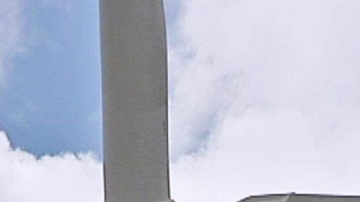 A close up of a wind farm turbine.