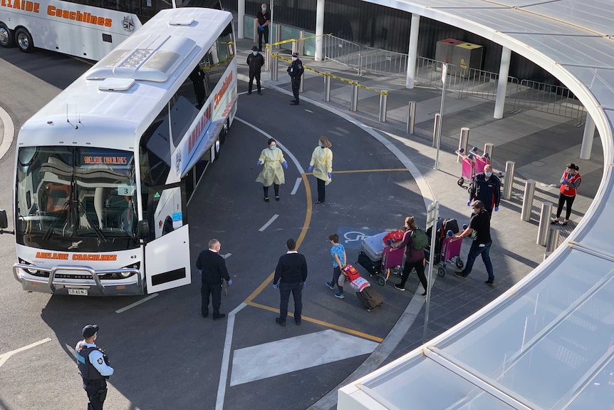 Passengers arriving at Adelaide Airport board coaches.