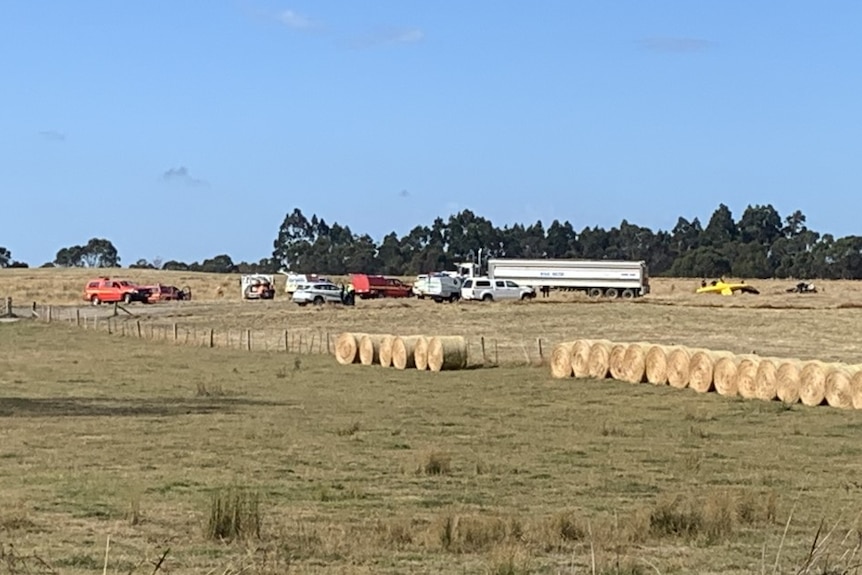 A field with various vehicles in the distance