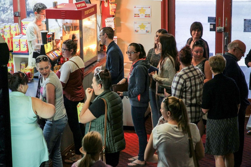 Movie-goers queue in the foyer of Broken Hill's Silver City Cinema.