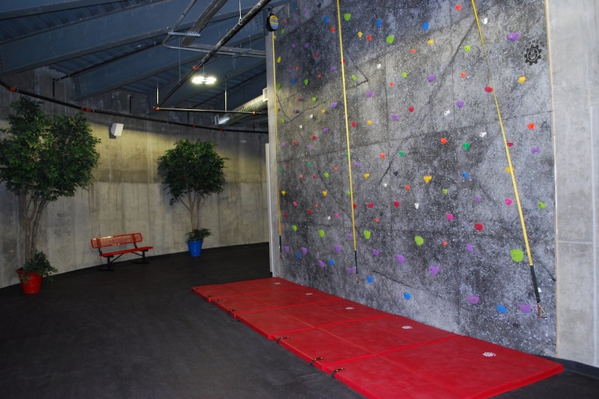 A rock-climbing wall in an underground bunker.