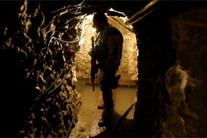 A Police agent with U.S. Immigration and Customs Enforcement stands guard in a drug tunnel found along the Mexico/USA Border....