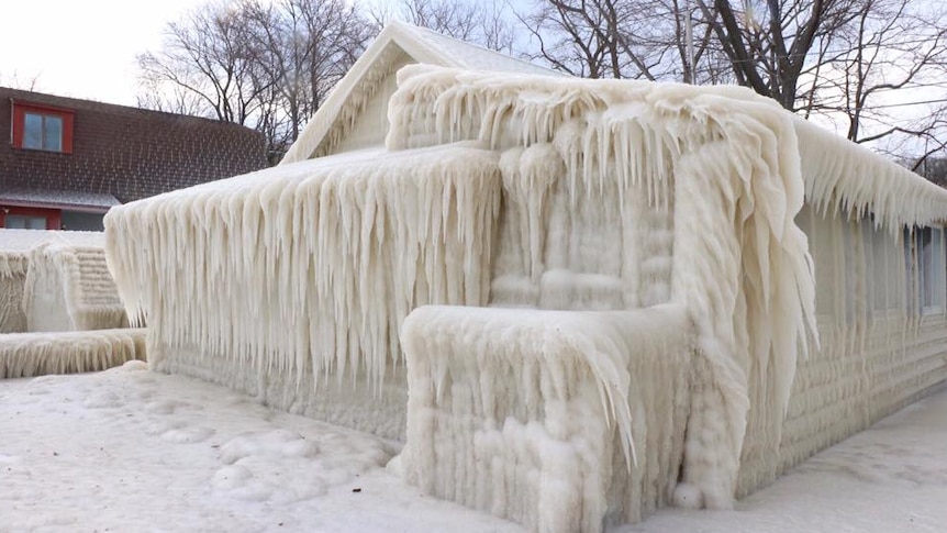House completely covered in thick layer of ice