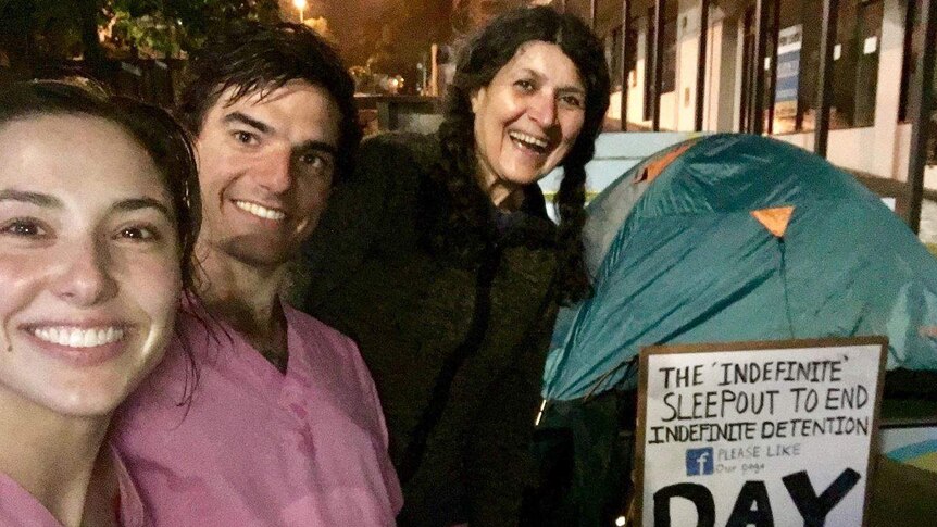 Three people get ready to sleep-out for refugees