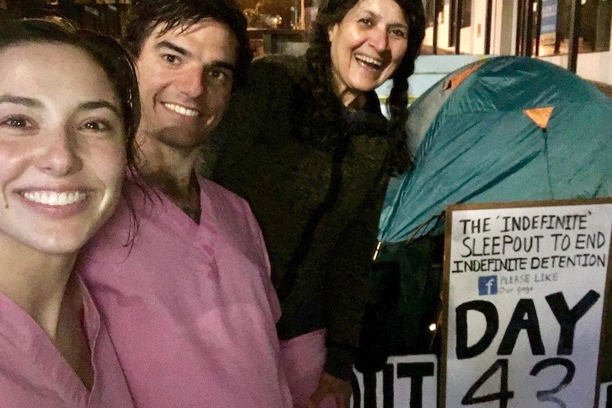 Three people get ready to sleep-out for refugees