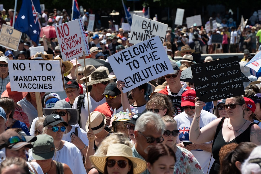 Donald Trump references pictured on signs and caps worn by protesters at a rally