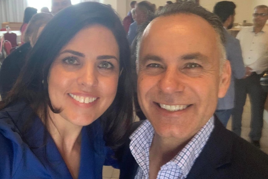 Moira Deeming and John Pesutto smile for a selfie at an event, with both showing very broad smiles.