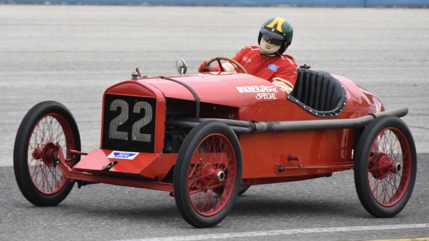 Old red race car on race track 