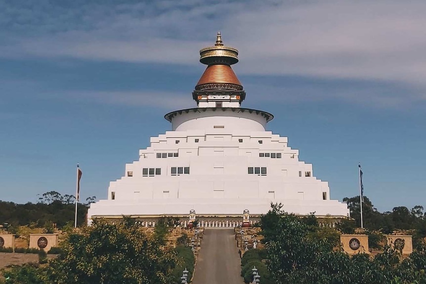 A Buddhist monument with a golden crown