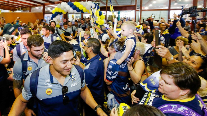 Jason Taumalolo absorbs the fans' adoration at Townsville Airport