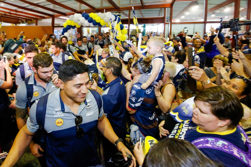 Jason Taumalolo absorbs the fans' adoration at Townsville Airport