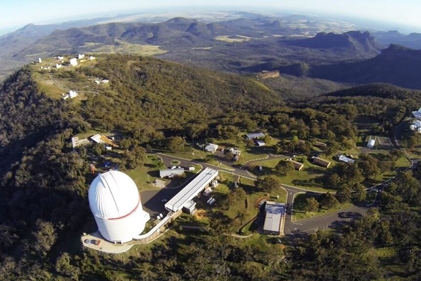A shot of the Siding Spring Observatory complex from above, showing the main viewing domes and accompanying buildings