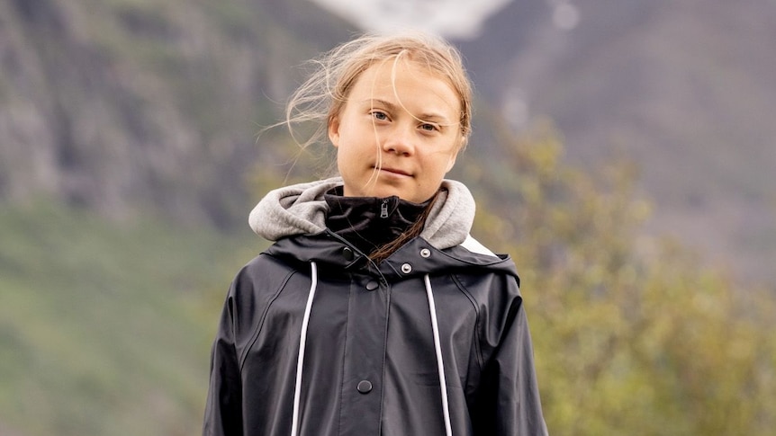 Greta Thunberg wearing a rain jacket in the Swedish mountainside.