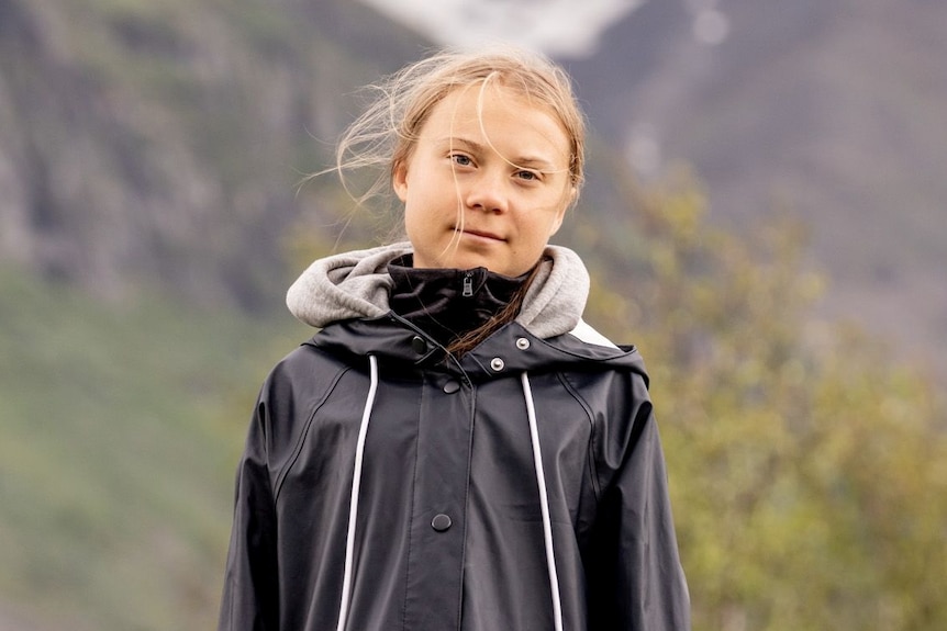 Greta Thunberg wearing a rain jacket in the Swedish mountainside.