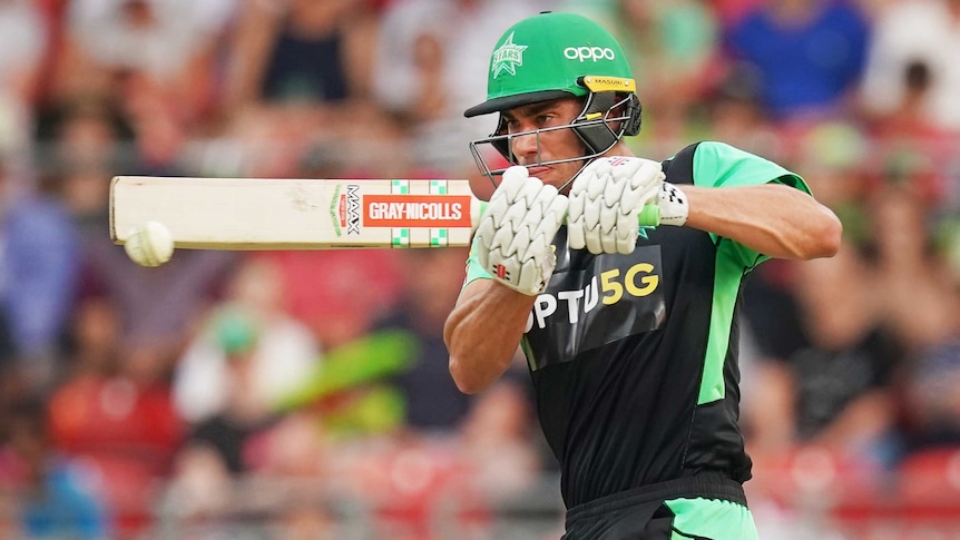 A helmeted batsman plays a cross-bat shot in the Big Bash League.