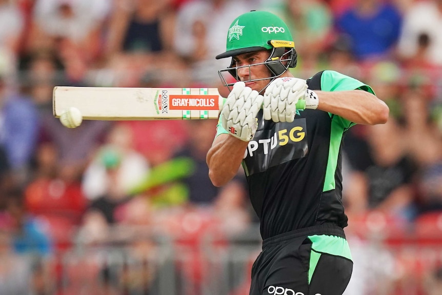 A helmeted batsman plays a cross-bat shot in the Big Bash League.