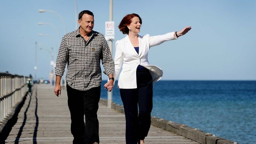 Julia Gillard and her partner Tim Mathieson walk along Altona pier in Melbourne the morning after the election