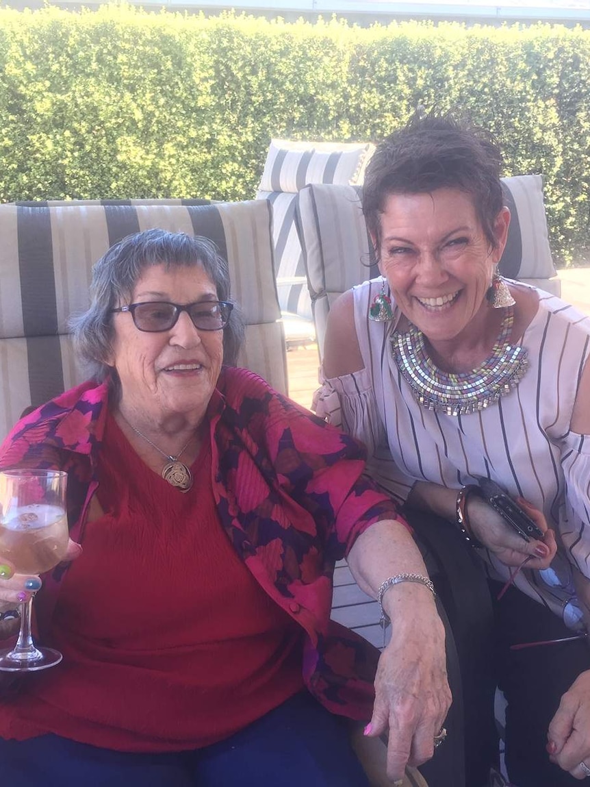 Louise Murphy with her mother sitting in chairs and smiling.