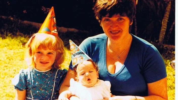 Film photo of baby Nadine von Cohen being held by her mother, beside her older sister in a story about keeping possessions.