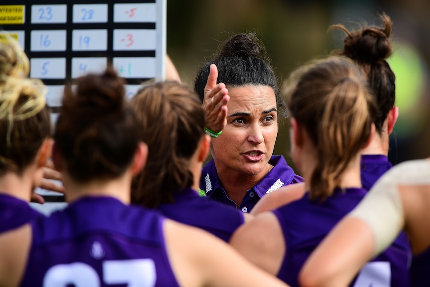 Michelle Cowan gesticulates while coaching players on the field