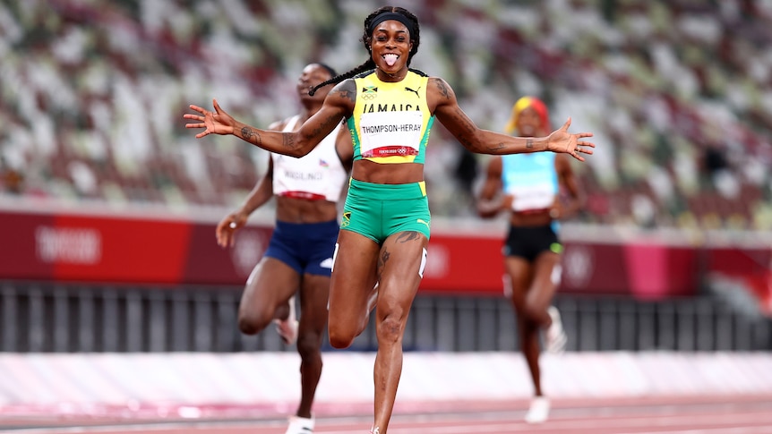 A Jamaican female sprinter sticks her tongue out after winning the 200m final at the Tokyo Olympics.