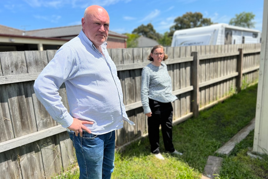 Steve Harrison and Sharon Harrison stand beside the fencer of their Inverloch home