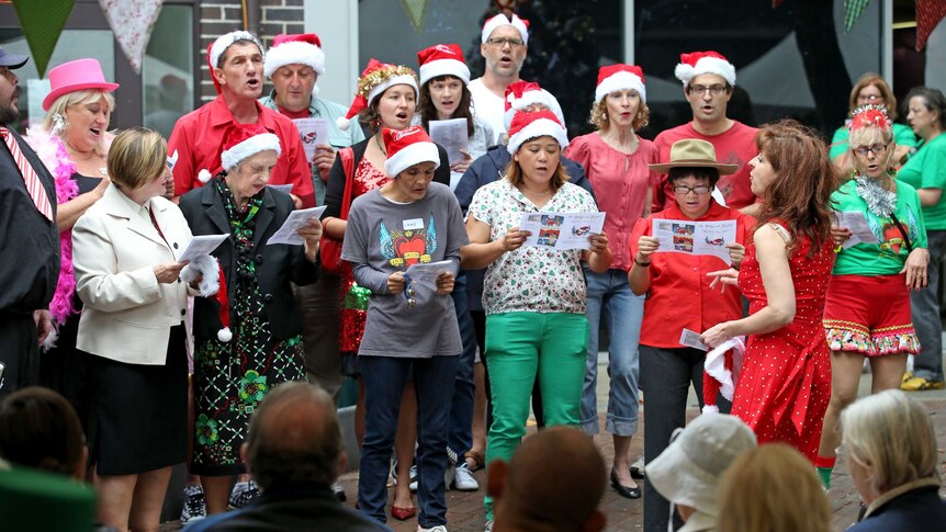 People sing carols at Wayside Chapel