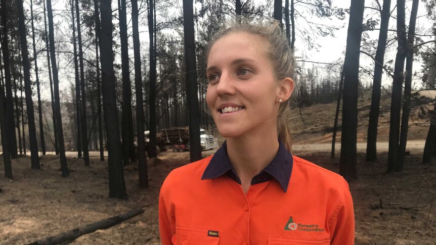 Forestry Corporation harvesting supervisor, Elle Kromar, wearing an orange work shirt