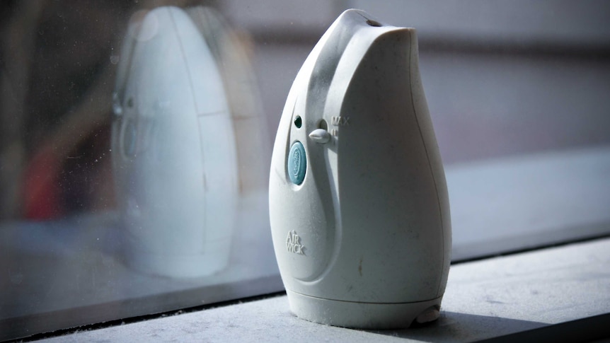 An air freshener sitting on a window sill.