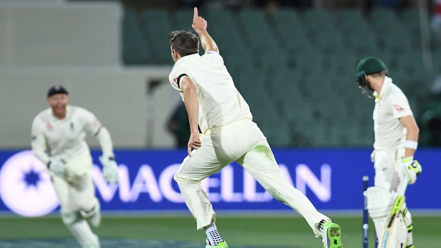 Craig Overton celebrates his wicket as the seats at Adelaide Oval sit empty.