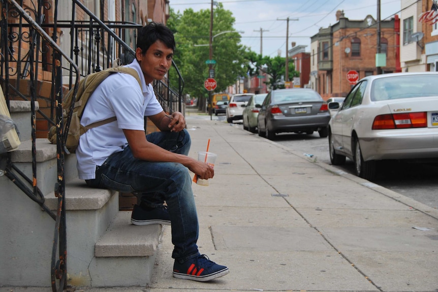 Mohammad Ayas sits on a set of stairs in Philadelphia.